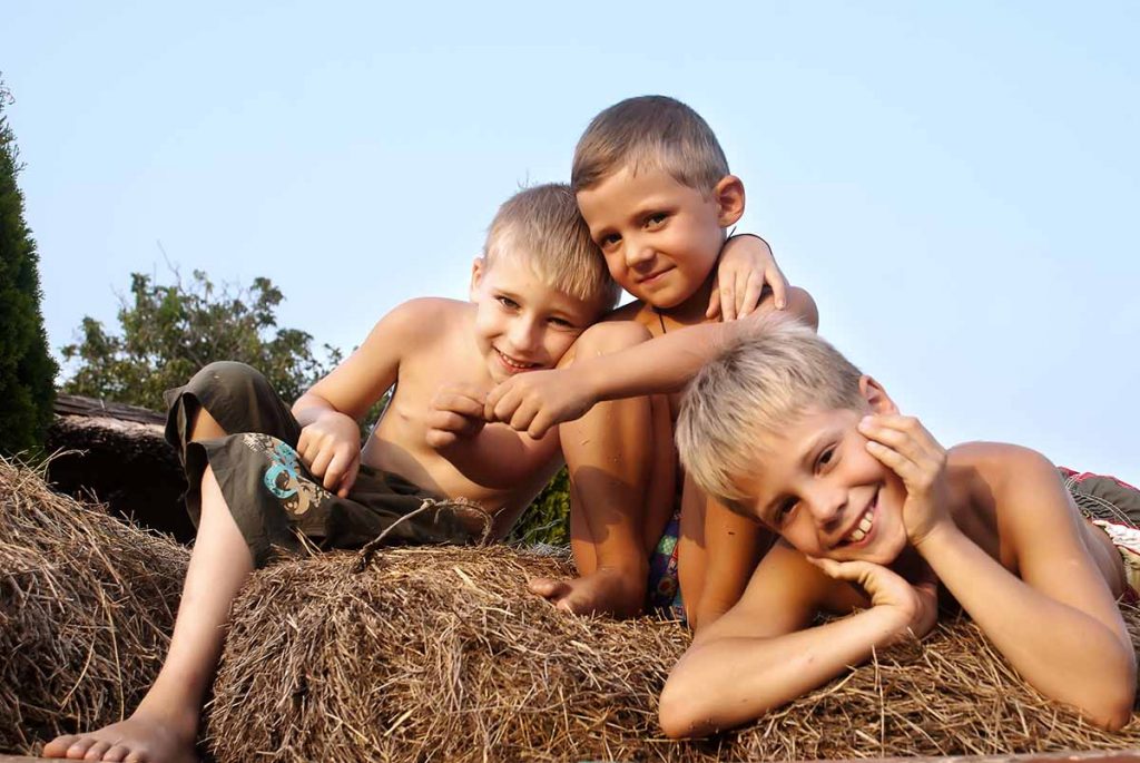 Children Laying On Hay Bale (1)